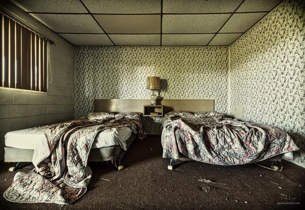 Messy bed in an abandoned motel.